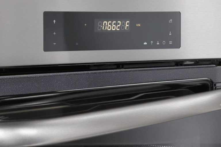 A stainless steel oven featuring a digital clock, ideal for appliance repair service needs.